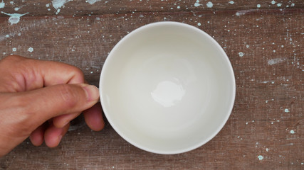 White cup on wood table.