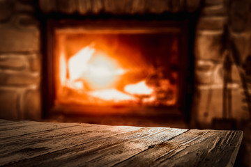 Desk of free space and blurred background of home interior with fireplace 