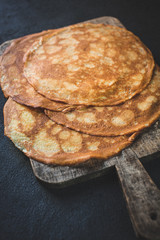 .Homemade, delicious pancakes on a simple wooden board. Crepes for breakfast.