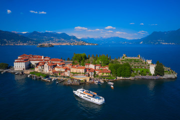 Fototapeta na wymiar Lake Maggiore, island, Isola Bella, Italy. A ship with tourists to the island. Aerial view of the island, Isola Bella