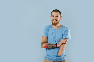 Happy bearded humble man without left hand over blue background