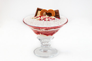 Layered dessert with fruits, nuts and cream cheese in glass jar, selective focus