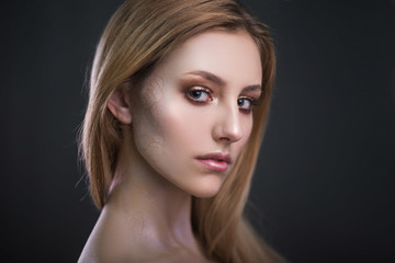 Studio portrait of a model. Body art gray roses. Beautiful girl on gray background