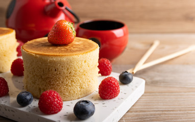 Trendy asian food, Fluffy homemade japanese souffle pancakes, hotcakes with raspberry, blackberry with copy space.