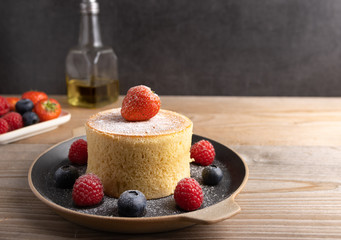 Trendy asian food, Fluffy homemade japanese souffle pancakes, hotcakes with raspberry, blackberry with copy space.