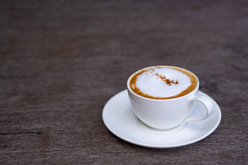 Cup of coffee cappuccino on wooden table. Space for text