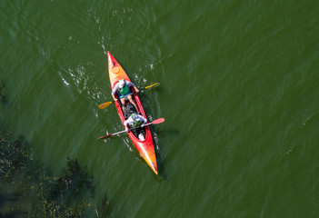 Ukraine, Zaporozhye, the Dnipro river, August 24, 2019 - two in a red kayak, view from above