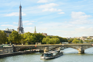 Cityscape with Eiffel tower, cruise boat, buildings, bridge