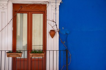window on the blue facade of the house in Bilbao city Spain