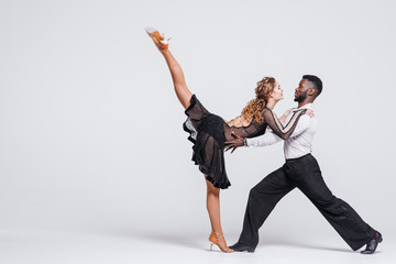 Couple dancers posing over white background. Dance school concept