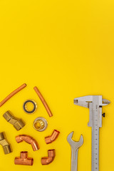 Set of tools for plumbing isolated on yellow background with space for advertising