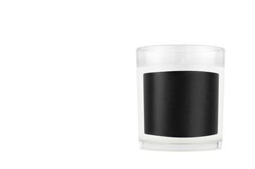 White candle in transparent glass with black blank label on isolated, mock up for branding identity...
