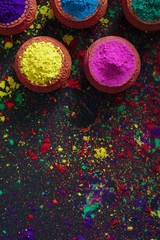 Fototapeta premium Indian Festival Holi, Colors in wooden bowl on dark background 