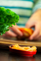 Salmon slices and woman preparing vegetables