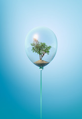 Minimal balloon concept with green tree inside. Minimal flying balloon ecology idea with growing tree on blue background. - obrazy, fototapety, plakaty