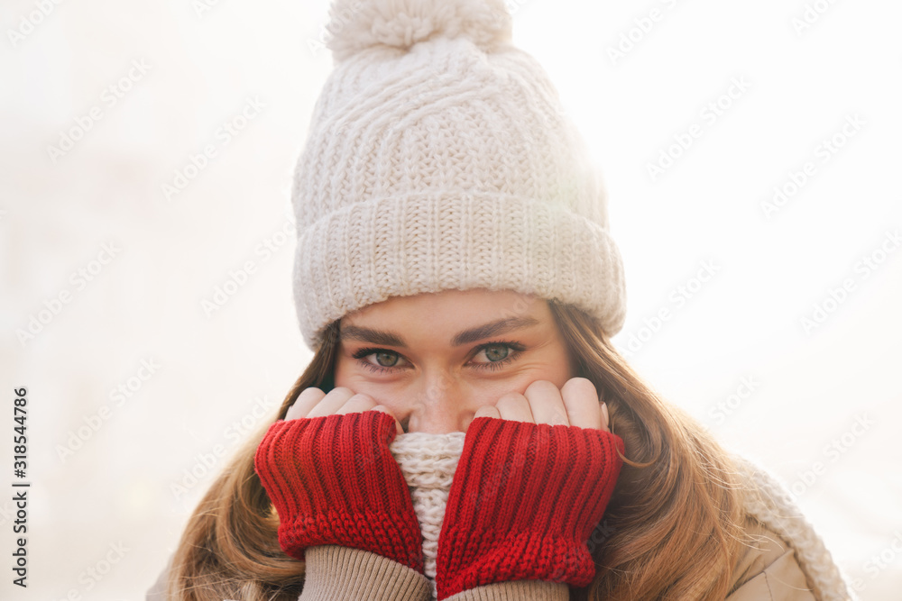 Sticker Close up of a cheerful pretty young girl wearing winter jacket