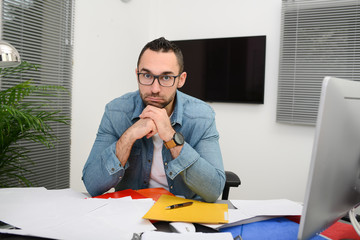Naklejka premium handsome man in office busy stressed headache paperwork burnout