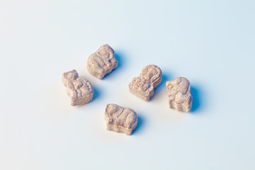 children's vitamins in the form of animals on a white background with light blue color