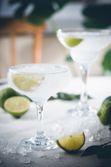 Refreshing Homemade Classic Alcoholic Margarita Cocktail with Lime and Salt on light background