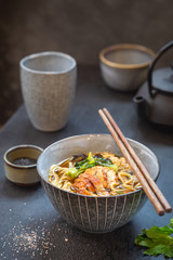 japanese soup with fried eel Yanagawa Nabe in a bowl on dark background