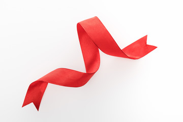 top view of red decorative curved ribbon isolated on white