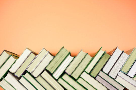 Many Books Piles. Hardback books on wooden table. Back to school.