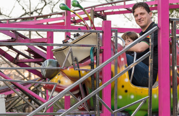 Boy, Caucasian, Playing in Toy, Carousel, Amusement Park