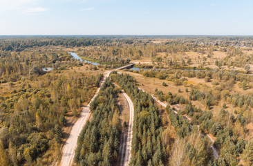 wooden bridge over a winding river, view from above