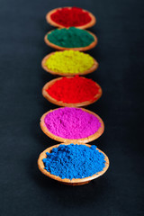 Indian Festival Holi , Colors in wooden bowl on dark background