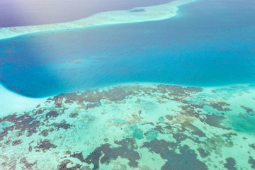 Background image of the turquoise sea. Deep sea and corals. Top view of beautiful Caribbean Sea. Aerial drone shot of turquoise water - space for text. Aquamarine background