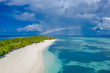 Aerial landscape, tropical island with stormy clouds and rainbow. Tranquil scenery, relaxing beach,...