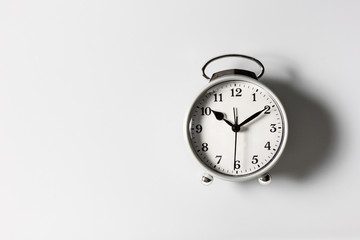 A white alarm clock on a white background