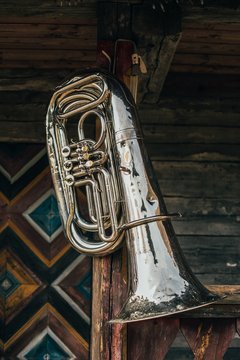 Old tuba on wooden wall