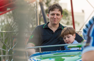 people, Boy, Caucasian, Playing in Toy, Carousel, Amusement Park