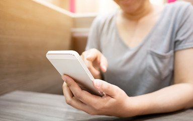 Close up image hand of woman using her mobile smartphone