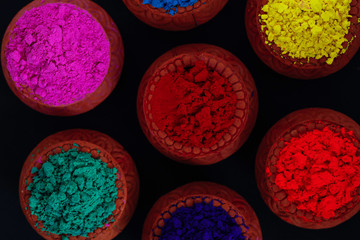Indian Festival Holi , Colors in wooden bowl on dark background