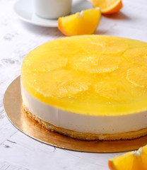 Homemade delicious sweet passion fruit orange cake, mousse dessert on cup of coffee americano, white background. Organic dessert sugarless. Healthy eating.