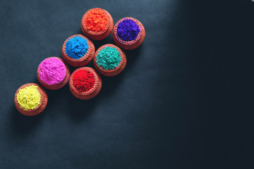 Indian Festival Holi , Colors in wooden bowl on dark background