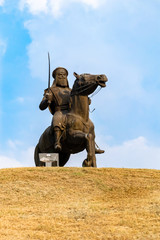Sikh Warrior statue on horse and holding a sword against sky in the background. memorial park concept.