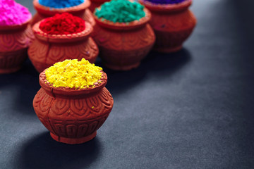 Indian Festival Holi , Colors in wooden bowl on dark background