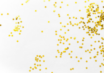 Gold confetti and stars and sparkles on a light background. Top view, flat lay. Copy text. Bright...