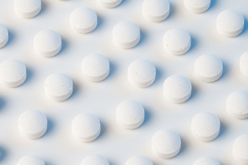 white pills on white background with blue lights