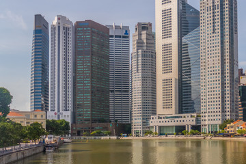 Fototapeta na wymiar Singapore City, Singapore - 07 19 2015: Singapore Reflection Of Modern High Skyscraper Buildings And Its River At Day.