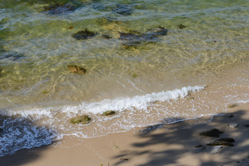 beautiful tropical sea beach with stones on the shore