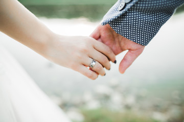 Wedding couple holding hands, groom and bride together on wedding day