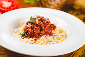 Spaghetti bolognese with tomato sauce, minced meat and grated parmesan cheese. Italian pasta.