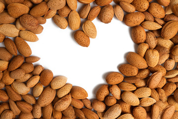 almond heart. copy space in the shape of a heart on a background of unpeeled almonds