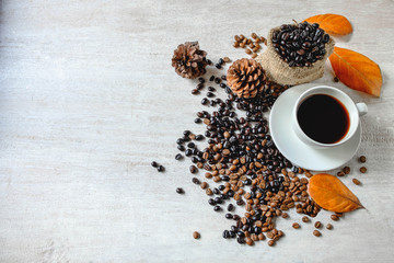 Coffee cups and coffee beans on a white wooden table