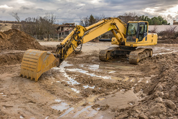 Work on a building site in winter with heavy machinery