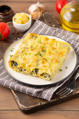 Italian cannelloni pasta with ricotta and spinach, traditional delicious food with cheese